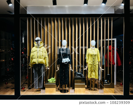 Showcase of a store in a mall with women outerwear 108239309