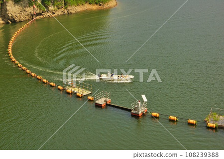 A boat maintaining the netting area of Lake Arao at Naruko Dam 108239388