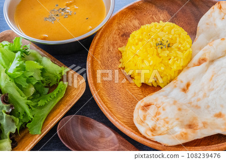 Indian curry and naan turmeric rice table background material 108239476