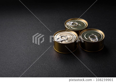 Round metal can with canned fish or meat with a key 108239901