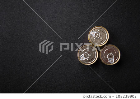 Round metal can with canned fish or meat with a key 108239902
