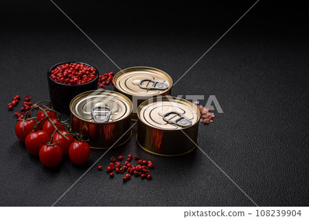 Round metal can with canned fish or meat with a key 108239904