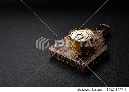 Round metal can with canned fish or meat with a key 108239914