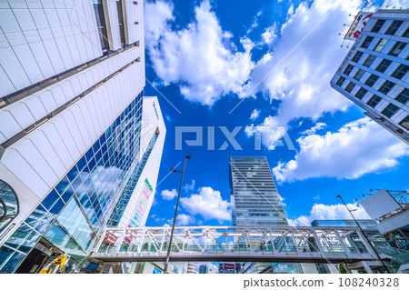 Tokyo cityscape in Japan in October, looking in front of Odakyu Shinjuku Station. JR Shinjuku Station south exit in the back Tokyo cityscape in Japan in October, looking in front of Odakyu Shinjuku Station. JR Shinjuku Station south exit in the back 108240328