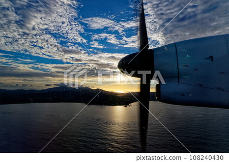 Clouds reflected in the airplane window during the sunset 108240430
