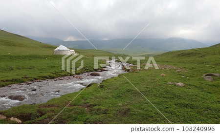 White yurt among green fields and rivers 108240996