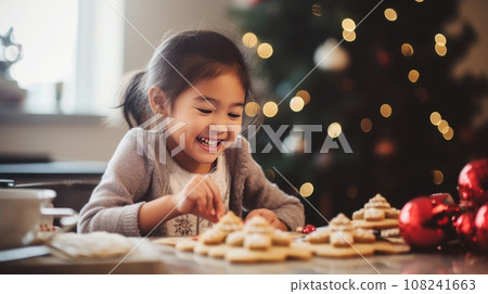 Smiling Asian child decorating Christmas cookies 108241663