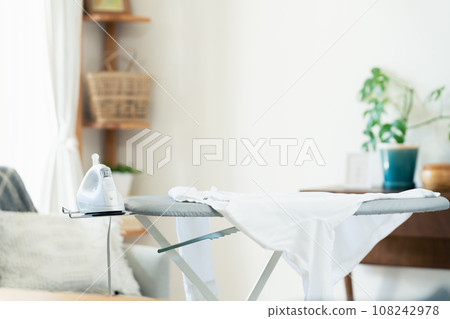 Ironing board and iron in the living room Ironing board and iron in the living room 108242978