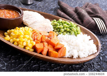 lunch box with rice, carrot, corn and chicken meat 108244604