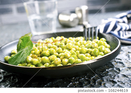 Green peas in the black bowl Green peas in the black bowl 108244619