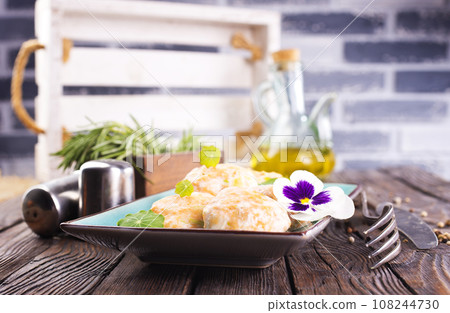 Chicken patties or fish cakes fried in breadcrumbs with ketchup Chicken patties or fish cakes fried in breadcrumbs with ketchup 108244730