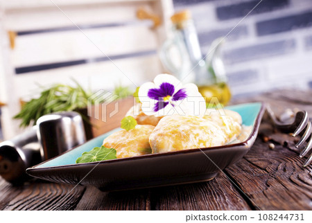 Chicken patties or fish cakes fried in breadcrumbs with ketchup 108244731