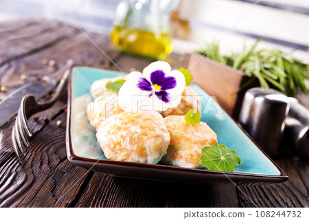 Chicken patties or fish cakes fried in breadcrumbs with ketchup 108244732