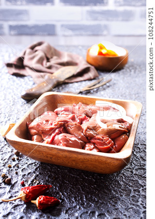 Raw liver with onion in wooden bowl 108244751
