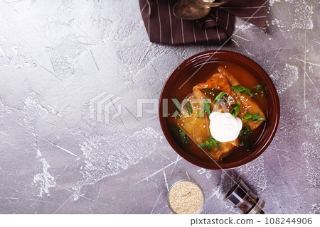 Stuffed cabbage with tomato sauce decorated with parsley 108244906