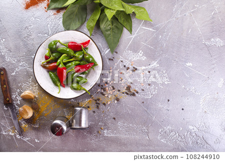 Red and green Chillies on white plate Red and green Chillies on white plate 108244910