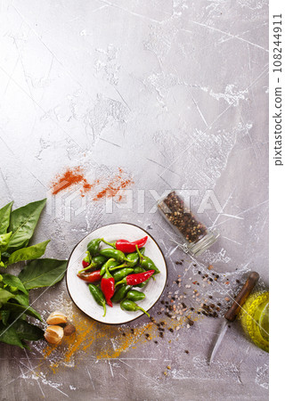 Red and green Chillies on white plate 108244911