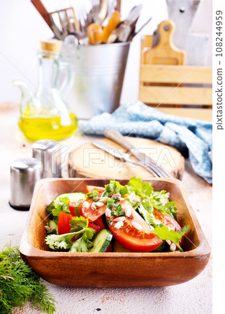 tomato, cucumber and onion salad in wooden bowl. fresh salad tomato, cucumber and onion salad in wooden bowl. fresh salad 108244959