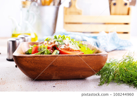 tomato, cucumber and onion salad in wooden bowl. fresh salad tomato, cucumber and onion salad in wooden bowl. fresh salad 108244960