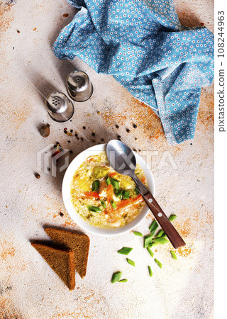 Pea soup with pieces of bacon and parsley in a bowl on white background. Selective focus 108244963