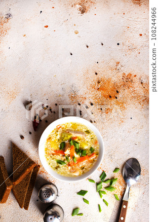 Pea soup with pieces of bacon and parsley in a bowl on white background. Selective focus 108244966