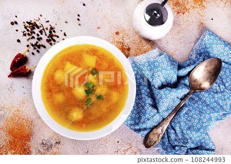 Pea soup with pieces of bacon and parsley in a bowl on white background. Selective focus Pea soup with pieces of bacon and parsley in a bowl on white background. Selective focus 108244993
