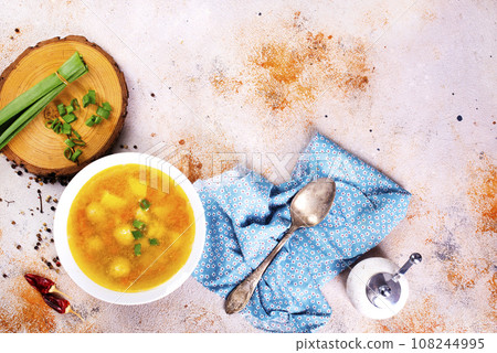 Pea soup with pieces of bacon and parsley in a bowl on white background. Selective focus 108244995