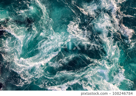 Blue waves of water of the river and the sea meet each other during high tide and low tide. Blue waves of water of the river and the sea meet each other during high tide and low tide. 108246784