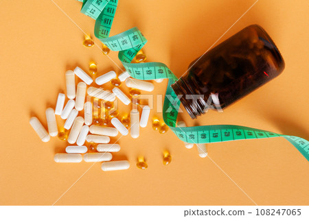 Weight Loss Pills and Measuring Tape, Diet Supplements Capsules, Obesity Lose Tablets, Color Drugs Pile 108247065