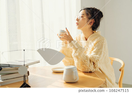A woman drinking coffee 108247515