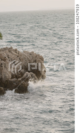 sea waves crushing over rocks with soft light 108247919