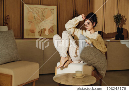 A woman relaxing in the room 108248176