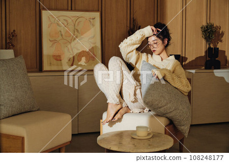 A woman relaxing in the room 108248177