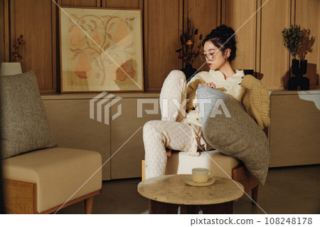 A woman relaxing in the room 108248178