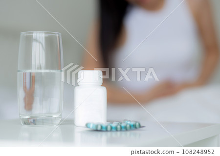 Young asian woman sitting on bed pain stomach or bowel with disease constipation or indigestion. Young asian woman sitting on bed pain stomach or bowel with disease constipation or indigestion. 108248952