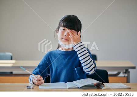 Elementary school girl with itchy eyes due to hay fever Elementary school girl with itchy eyes due to hay fever 108250533
