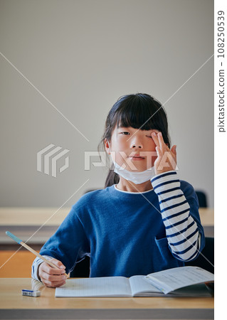 Elementary school girl with itchy eyes due to hay fever Elementary school girl with itchy eyes due to hay fever 108250539