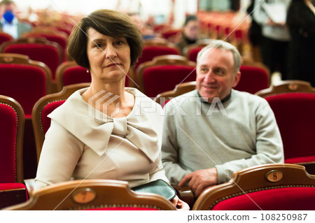 Man and a woman in the theater watching a performance 108250987