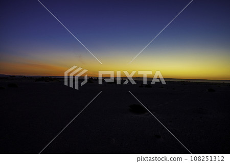 Sunrise and clear horizon in the Sahara desert of Morocco Sunrise and clear horizon in the Sahara desert of Morocco 108251312