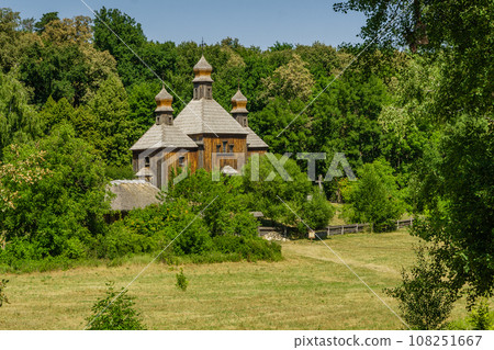 Old wooden church on a background of blue sky Old wooden church on a background of blue sky 108251667