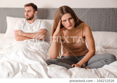 Unhappy couple with relationship problems after quarrel in bedroom 108252026