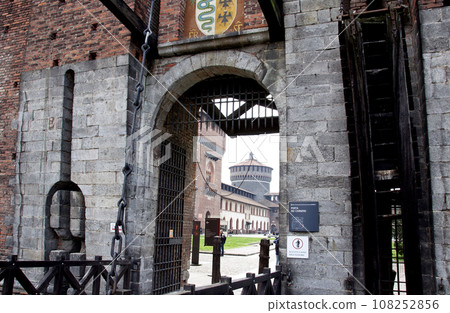 The Tower of the Holy Spirit can be seen from the entrance of Castello Sforzesco, a fortress in Milan, Italy (blurred face of person) 108252856