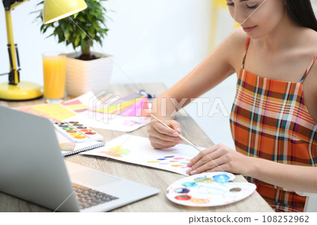 Female designer working at desk in office Female designer working at desk in office 108252962