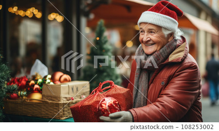 sale, winter holidays and people concept - happy senior couple with gift bags at christmas market 108253002