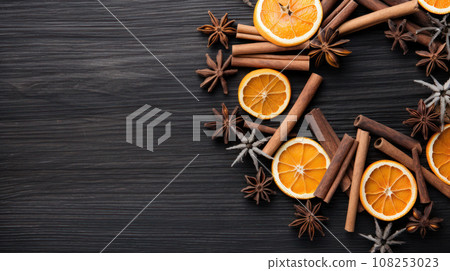 Christmas composition. Wreath made of spices and dry oranges Flat lay, top view, copy space 108253023