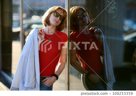 Close-up Portrait of Stylish Redhead Woman in Urban Autumn Fashion Close-up Portrait of Stylish Redhead Woman in Urban Autumn Fashion 108253359