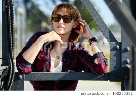 Close-up Portrait of Stylish Redhead Woman in Urban Autumn Fashion 108253391