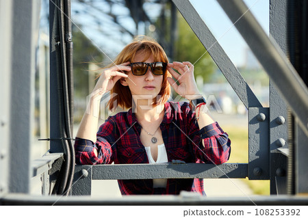 Close-up Portrait of Stylish Redhead Woman in Urban Autumn Fashion 108253392