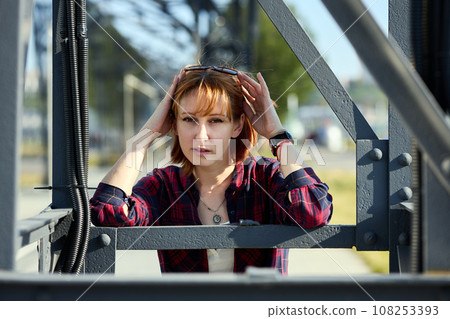 Close-up Portrait of Stylish Redhead Woman in Urban Autumn Fashion 108253393