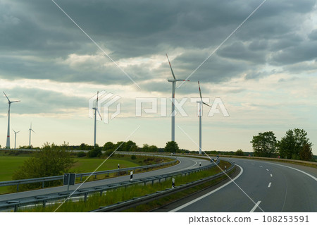 Wind turbines of a wind farm standing along the road. 108253591